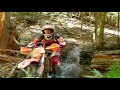 Jumping into a crick bed on a motorcycle