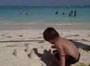 Leah and Fuyuko out in the turquoise water while Alec manages our sandcastle fortifications.