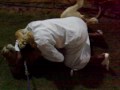 Play-wrestling with pet lion.
