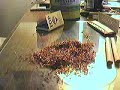 Rolling a cigarette.