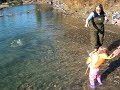 Julia catches a salmon in Alaska