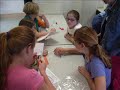 knoxville area girl scouts competite in an a world in motion jet toy race sponsored by swe and ut sae.