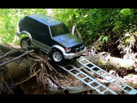 SCALE RC TRUCKS wading through water.