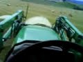 paul in the john deere 6220 gathrin bales