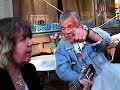 Crazy old woman at the local bar singing and playing...