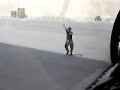 Bomber crew chief marshaling a jet