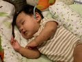 Adorable baby laughing while sleeping