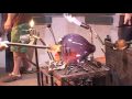 another pauwela cannery saturday event put on by dafactory da factory productions - this footage includes highlights of kenny tilton - distinguished wood carver from hawaii who makes traditional wooden surfboards from mango koa and other local woods - also jason harris charles lowrie raman anderson guisseppi scalgione - the pieces made was part of a series of pieces of which one has been presented to the dali lama during his maui visit in april 2007 - the piece is titled sphere of consciousness and is a hanging globe of amethyst glass that surrounds a white lotus flower - the performance was enhanced with music by the band portal the incredible jam based band from maui