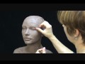Sculpting a female head in clay