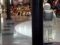 ASIMO runs back to the other side, then walks to the front. He seems to be demonstrating his many degrees of freedom of mobility in his arms and hands by doing THE ROBOT and generally gettin jiggy wi