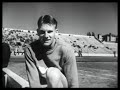 Cornelius Warmerdam sets pole vault record. General crowd scenes. CU Cornelius Warmerdam. Tilt-up of pole to Warmerdam. Officials measure jump. CU setting pole at 15 ft. 6-7/8 inches. Warmerdam walks to camera. CU Warmerdam jumping. Slow motion jump. Warmerdam being congratulated and shaking hands.