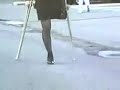 One-legged female street crutching
