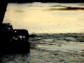 Tugboat going under bridge