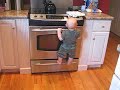 Ian climbs up the oven