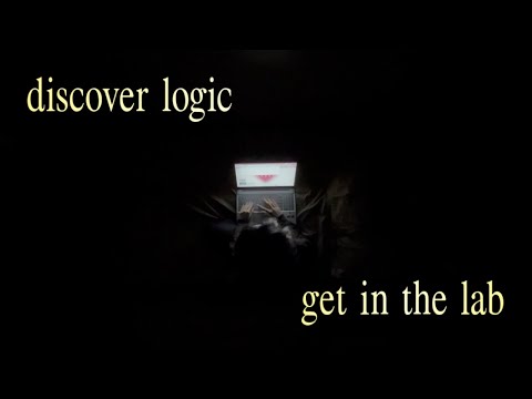 dark room with open laptop and hands typing