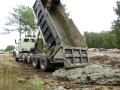 Dump trucks dumping mud