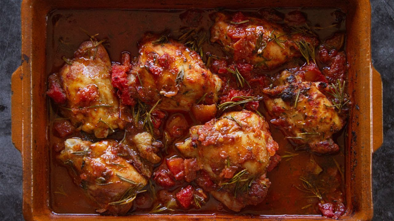 Roast chicken thighs with red wine, tomato, and herbs.