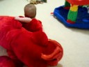 Twin girls playing with plush lobster