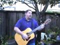 scrappy singing an acoustic folk original song on his 12 string