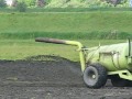Barack Obama on a tractor fertilizing his back forty.