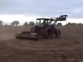 Rolling a field after sowing grass seed.New Holland