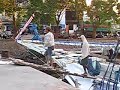 incredible footage of men in makassar, sulawesi indonesia carrying bags of sugar on their shoulders assembly line style onto a port.  you can also hear the mosques in the background. this is a very famous port town in indonesia.
