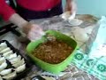 Woman wrapping Chinese dumplings (dim sum ?? ?? shu?ji?o)