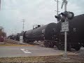 Clip 702, with three locomotives, heads to Durand with 77 cars seen here crossing JFK Dr. in Bay City. Video