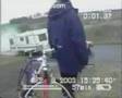Bicyclists watch car and trailer roll down hill