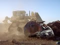 Armored D9 Dozer crushing cars in Iraq