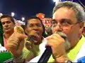 Desfile da Estação Primeira da Magueira no Carnaval 2007Quem sou eu Tenho a mais bela maneira de expressar Sou Mangueira...uma poesia singular Fui ao Lácio e nos meus versos canto a última flor Que espalhou por vários continentes Um manancial de amor Caravelas ao mar partiram Por destino encontraram o Brasil... Nos trazendo a maior riqueza A nossa língua portuguesa Se misturou com o tupi, tupinambrasileirou Mais tarde o canto do negro ecoou Assim a língua se modificouEu vou dos versos de Camões Às folhas secas caídas de Mangueira É chama eterna, dom da criação Que fala ao pulsar do coraçãoCantando eu vou Do Oiapoque ao Chuí ouvir A minha pátria é minha língua Idolatrada obra-prima te faço imortal Salve... Poetas e compositores Salve também os escritores Que enriqueceram a tua história  Ó meu Brasil Dos filhos deste solo és mãe gentil Hoje a herança portuguesa nos conduzNa Estação da LuzVem no vira da Mangueira vem sambar Meu idioma tem o dom de transformar Faz do Palácio do Samba uma casa portuguesa É uma casa portuguesa com certeza