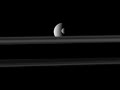 Saturn's moon, Mimas passes in front of the larger moon Rhea