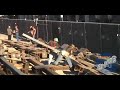 dallas and travis hoist a column at the construction site of the new school of cinematic arts at the university of southern california