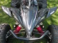 My brand new 2009 YFZ450R SE. Here are a collection of pictures of it without plastic and with a few accessories. All the skid plates are GYT-R and so are the nerf bars. I got the Vapor Trail Tech device installed, but it's original location was in the middle of the bars which requires the removal of the plastic bar cover. It looks better with the cover there and its not that stable there with the stock bar clamp, it hits the left handlebar clamp bolt. So I decided to move it's location as you can see. It's more stable there and I get to put the stock bar cover on. This does require some rewiring though because the wires move and require more length when the bar turns. I extended the wire from the battery and moved the others so they had plenty of slack. The wire from the radiator hose I decided to leave on the outside so I was for sure it would have enough slack. The way I routed it, it should have no problem getting caught on any branches or anything. And yes the blue Pro Design kill switch, this was from my previous (blue) YFZ450. I'm hoping you can use the pictures if you need to see how something went together after you took it apart and also if you had any questions I could give you my opinion and/or try to help you out. The quick-release fasteners for removing the plastic work really well so far, the way the plastic was designed and put together is the best I've seen so far. The link to the homepage for the 2009 YFZ450R SE is www.yamaha-motor.com