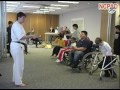 Photo of a martial arts class instructor teaching youth with disabilities.