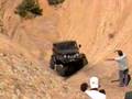 Jeep rolls down a rock