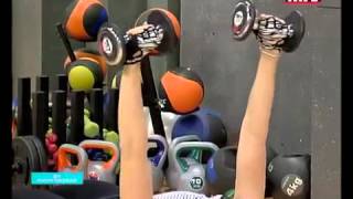 Full body workout using a Swiss ball and a pair of dumbbells