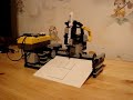 Made for the lego building instruction site by Laurens200http://ricquin.net/lego/instructions/Building instructions are found here:http://ricquin.net/lego/instructions/plotter.htmUpdate: Instructions updatedIt is made with a single RIS 2.0 kit and another motor.When you start it, a timed test run will happen. This will be used to messure all distances later in the program. This is my attemt to elliminate differences when the batteries are less charged.The pen are resting in the holder and not directly connected with the motor. This is to prevent it applying too much weight to the paper. When it is lowered, the lever holding it up goes down so it jams on some bricks and the pen is resting on the paper.To create a even surface to write on, the paper is curved and suporting itself.One touch sensor is used to report when the pen have reached it outermost points. A lightsensor can be attached beneth the pen and be used to scan an image, but haven't been tested.
