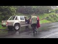 A driver almost comes to grief while negotiating a flooded Showground road in Narara on NSW Central Coast during a deluge of rain which swept the region including Sydney
