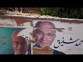 Click here to watch this video Effaced posters of presidential candidates