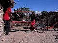 Lifting Bicycle ambulance stretcher from hut