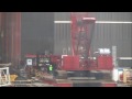 A manitowoc 16000 lifts a tower crane's main tower section at the world trade center at a big radius. To bad the windows werent cleaner..