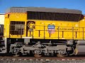 Union Pacific \"Oil Cans\" meets Metrolink train!