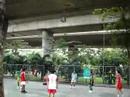Locals playing takraw below the rail track in Old Bangkok