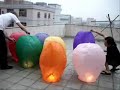 Mix Colored Sky Lanterns taking off in a group Mix Colored Sky Lanterns taking off in a group