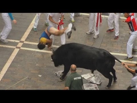 Excruciating moment a bull-runner gets gored at Pamplona in Spain