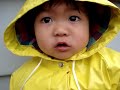 Singing in the rain baby toddler girl poses a smile and kiss