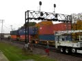 Long UP westbound stack train with DPUs passing MOW workers at Rochelle