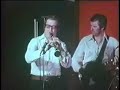 manone wingy in toronto 1976

wingy manone in toronto in 1976 in 1976 our climax jazzband got its big break. we were hired away from albert's hall on bloor street west, a smokey pub in the university area to go big time. in the brand new hydro building the owners of dj's tavern, a posh 330 seat restaurant-stand up bar with ample dance floor and a 3 foot high stage, wanted to open with a jazz policy. we appeared to be the most popular jazz band in town and were contracted to play 6 nights a week and have internationally renowned jazz musicians to be our featured guests. can you imagine that we had a chance to play with all these famous jazz men? i'll try to remember a few. trumpet players wingy manone, jimmy mcpartland, doc cheatham, joe thomas, max kaminsky. clarinet players kenny davern, joe muriani, henry cuesta, herb hall, trombonists vic dickenson, benny morton pianist don ewell singers carol leigh, pug horton, babe matthews and some more. full bands together with us like worlds greatest jazz band, soprano summit, dutch swing college band, george melly and his feetwarmers. i'm certain i have forgotton quite a few. it was an enormous learning experience. the unfortunate part was that i usually had to drive these artists to their hotel after the gig and then they wanted to socialize and tell their (hi)stories, but that was at 1.30 am.. now i regret it, but i had to refuse because my regular dayjob would demand i was in the office at 8.30. we opened with wingy manone. he was quite a character. at 76 he still had a lot of sparks and a great sense of humour which reflected in his announcements and also in the interplay between him and us in the band. jack teagarden scholar joe showler produced a movie of wingy with our band. one night he came in with a few camera men and the result is shown herewith. too bad that wingy would just start playing and many of the tunes are kind of dragging. but you can't complain if you are part of history in the making.