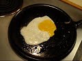 demo of frying eggs on a cast iron skillet